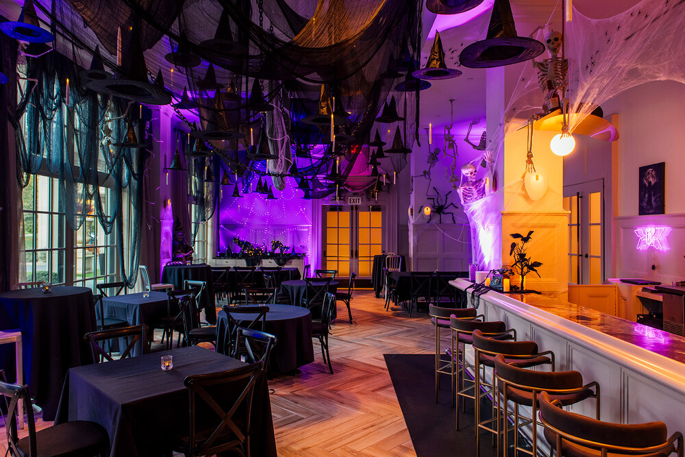 a room with tables and chairs and a purple light