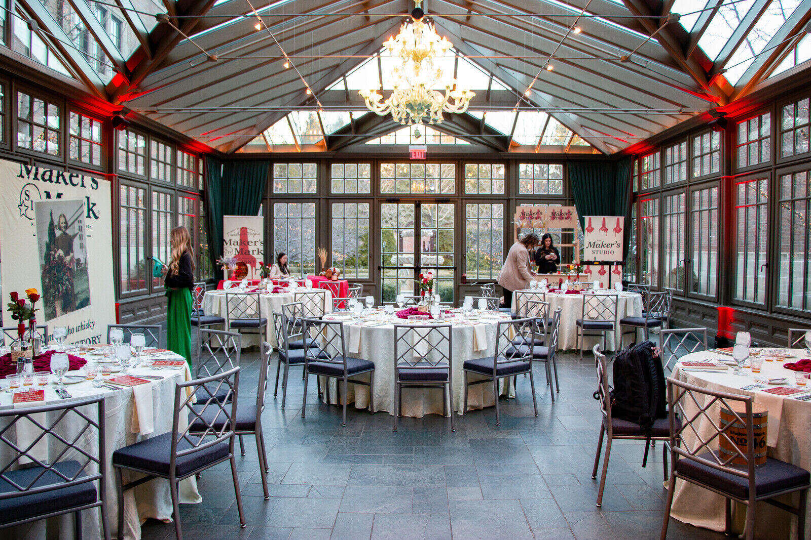 a glass room with chairs and tables